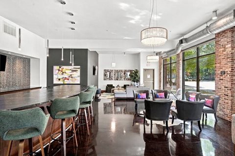 A modern dining room with a long table and chairs.